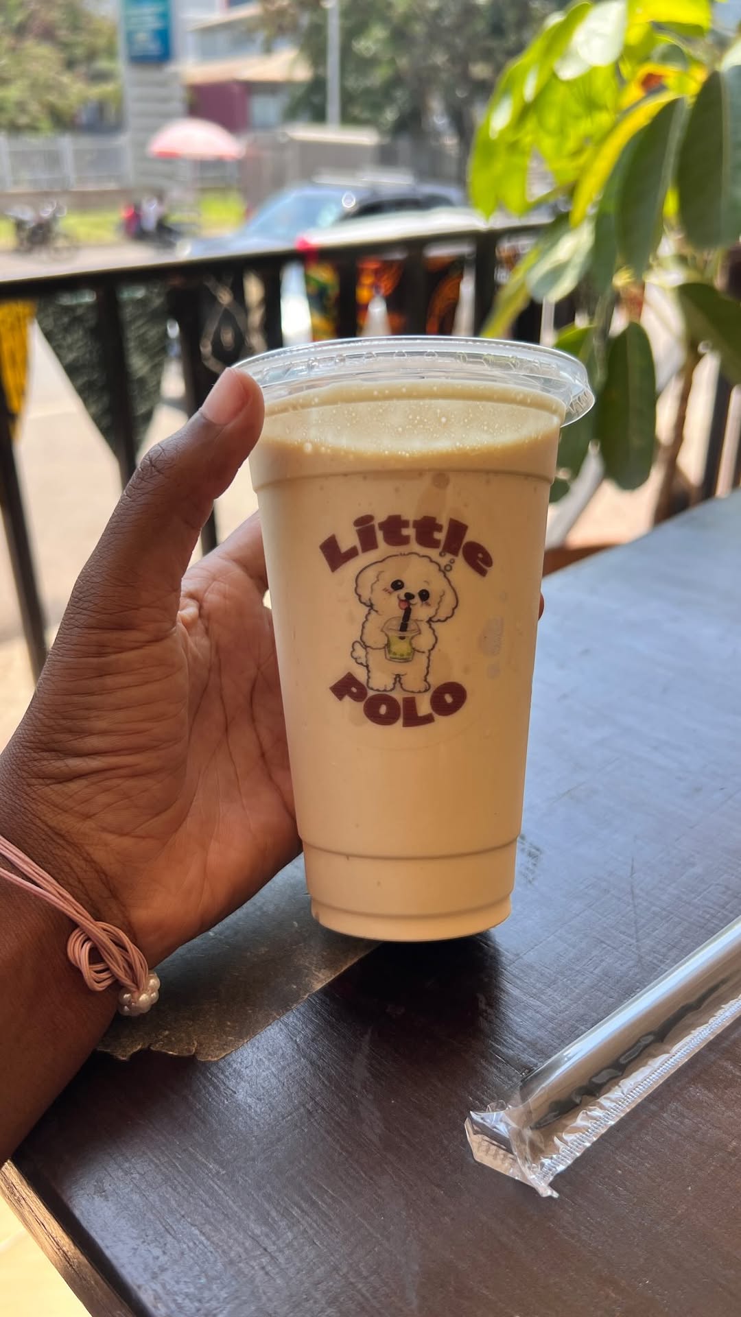 A creamy Little Polo Café drink held at the café